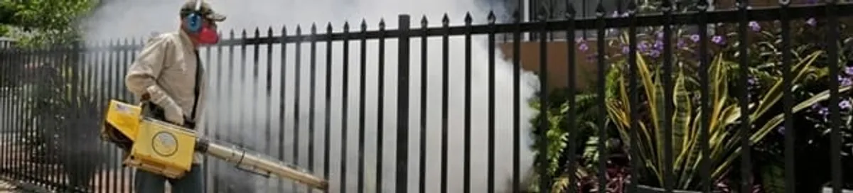 Mosquito control technician fogging a yard perimeter for mosquito reduction in Spokane, WA